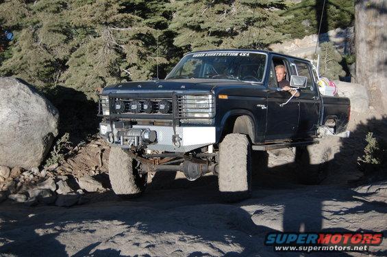 Black Ford F-Series pickup truck modified for off-roading, with large tires and a winch