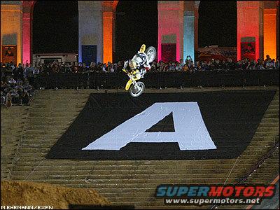 Motocross rider mid-air over a large white 'A' graphic