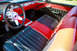 1959 Ford Ranchero - The interior of a 1959 Ford Ranchero features two-tone red and black seats and a matching dashboard.
