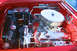 1959 Ford Ranchero - The engine bay of a red 1959 Ford Ranchero is detailed with chrome components.