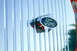 1959 Ford Ranchero - A close-up of a Ford emblem on a shiny chrome grille with vertical bars.