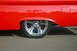 1959 Ford Ranchero - A bright red 1959 Ford Ranchero is shown from the side, a custom chrome wheel and lowered suspension.