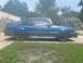 1989 Ford Mustang - Side view of a blue 1989 Ford Mustang hatchback with black wheels.