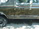 1988 Ford Bronco - This SUV's side panel shows significant damage and a decorative stripe.