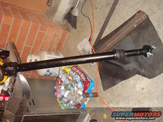 Driveshaft with a bag of water bottles and a propane tank