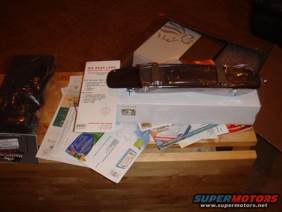 rear-view mirror on top of papers and boxes