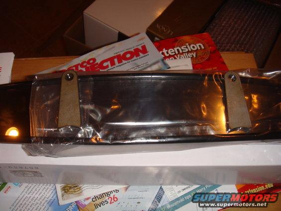 Chrome car part in plastic packaging with mounting brackets
