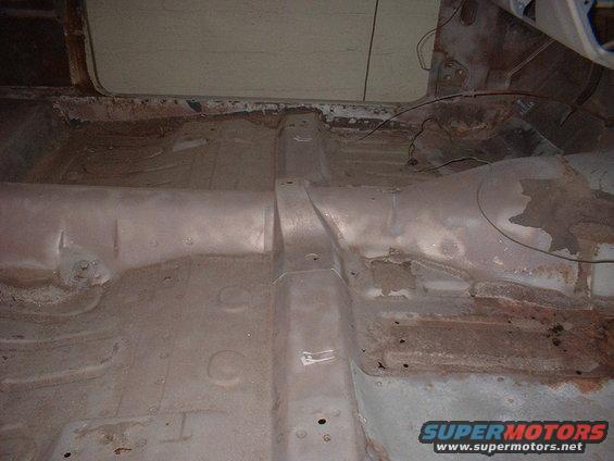Interior floor pan of a car showing rust and structural supports