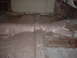 1964 Ford Fairlane - The interior floor pan of a car, showing rust and structural supports, is visible in this photo.