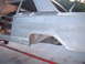 1964 Ford Fairlane - The rear section of a 1964 Ford Fairlane, shown in primer and undergoing restoration work.