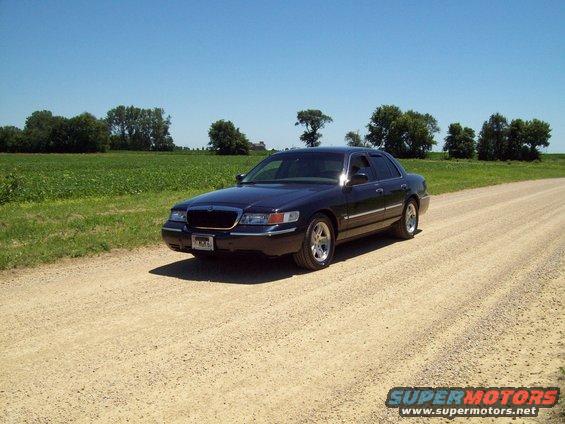 Dark blue 1999 Mercury Grand Marquis on a dirt road
