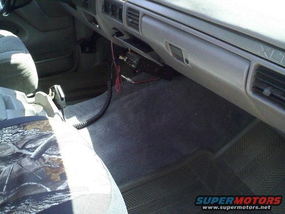 1994 Ford Bronco interior showing dashboard, passenger seat with camouflage cover, and CB radio