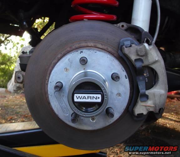 hub.jpg Warn manual locking hub, shown secured to the rotor using small screws (keeps the hub from coming off with the tire).
This is the stronger "Jeep" hub, but you couldn't tell just by looking at it... It's a good pound heavier than a standard-issue Ranger/BII hub (it's made of a much stronger alloy)
