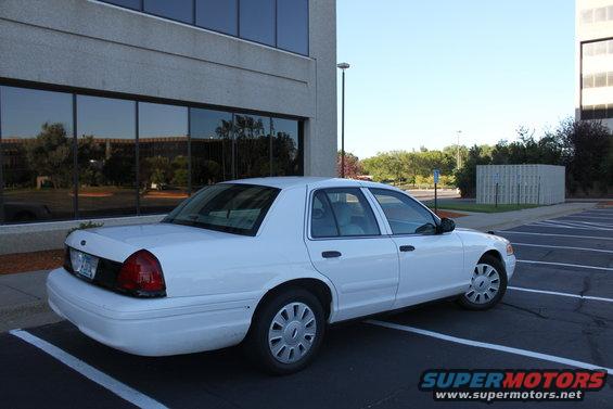 White 2003 Ford Crown Victoria parked in a lot, rear quarter view