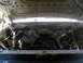 1996 Ford Bronco - Engine bay view of a 1996 Ford Bronco, showing a custom brace in the front suspension area.