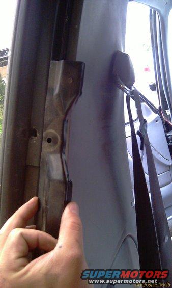 Interior trim panel and seatbelt in a vehicle