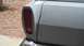 1968 Ford Ranchero - This photo shows the rear corner of a vehicle, focusing on the tail light and a dented body panel.