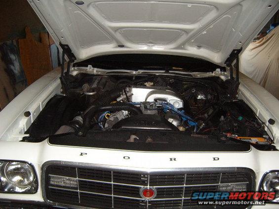 1973 Ford Ranchero engine bay with hood open, showing engine components and grille