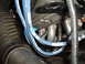 1973 Ford Ranchero - Close-up of engine components including blue Moroso spark plug wires and exhaust manifold.