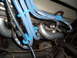 1973 Ford Ranchero - A view of the engine bay focuses on the spark plug wires and exhaust system components.
