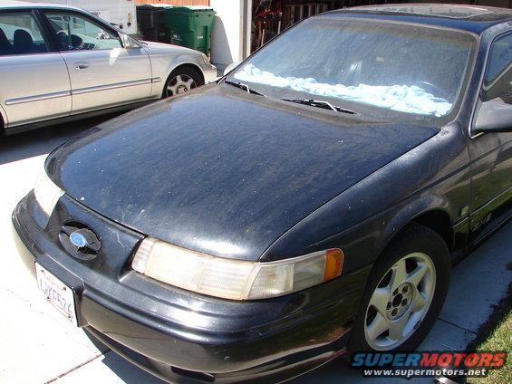 Front view of a black 1992 Ford Taurus parked next to a silver car