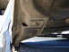 1992 Ford Taurus - Close-up view of the underside of a vehicle's hood, showing mounting hardware and structural components.