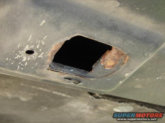 Rusted hole in underside of vehicle