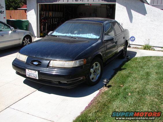 1992 Ford Taurus sedan parked in driveway, another car to the left