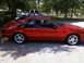 1989 Ford Mustang - Side profile of a red 1989 Ford Mustang coupe, aftermarket chrome wheels and a clean body style.