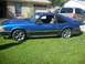 1989 Ford Mustang - A blue 1987 Ford Mustang coupe is parked on a grassy lawn in front of a house.