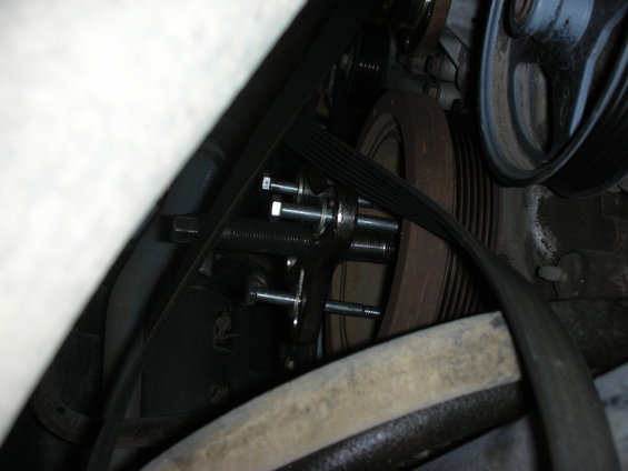2004 Ford Crown Victoria engine pulley system with a Steeda Underdrive pulley install tool attached to the crankshaft pulley