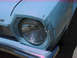 1972 Ford Pinto - Close-up of a car's front headlight and damaged fender.
