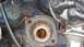 1968 Ford Ranchero - Close-up of an engine block's thermostat housing mounting area, showing rust and corrosion.