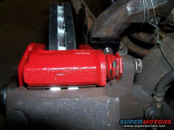 caliper-bracket-to-ranchero-spindle.jpg Shows the upper bolt coming through spindle bracket and how after everything is bolted in place, how the caliper is centered on the rotor