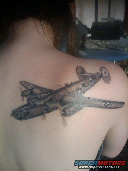 Tattoo of a twin-engine bomber airplane on a person's shoulder