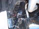 1973 Ford Ranchero - Close-up view of a vehicle's rear suspension system, showing a shock absorber and exhaust pipe.