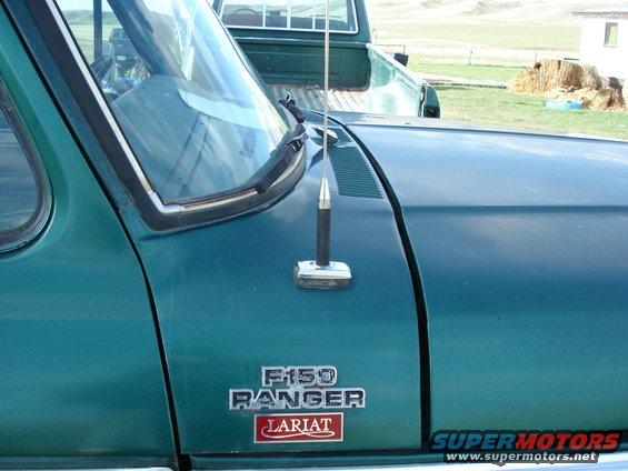 Green truck fender with F-150 Ranger Lariat badges and a chrome antenna