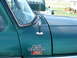 1979 Ford Bronco - Close-up of a green truck's fender shows F-150 Ranger Lariat badging and an antenna.