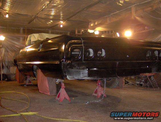 Black 1964 Chevrolet Impala rear body on jack stands, undergoing restoration