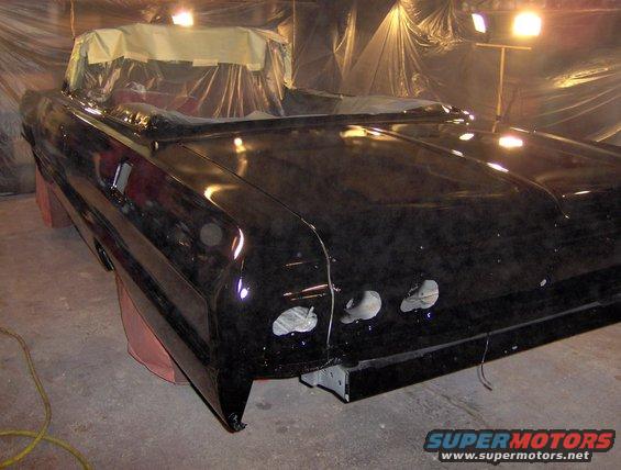 Black 1964 Chevrolet Impala convertible undergoing paintwork, rear quarter view