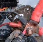 Close-up of corroded battery terminals and red wiring