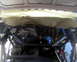 1996 Ford Bronco - The engine bay shows an aftermarket brace, with some components covered by protective paper.