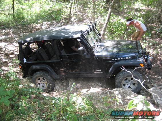 Black 2005 Jeep Wrangler Rubicon navigating a rocky off-road trail