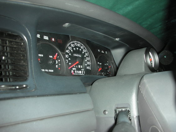 Interior dashboard of a 2004 Ford Crown Victoria with an Autometer tachometer installed