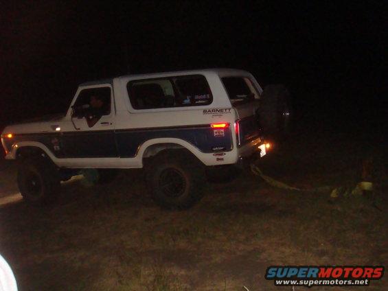White and blue Ford Bronco, 1978 model, with spare tire on rear