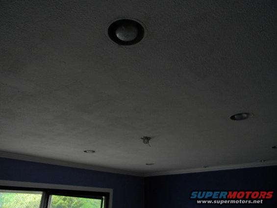 Interior ceiling with recessed lighting and a blue wall below