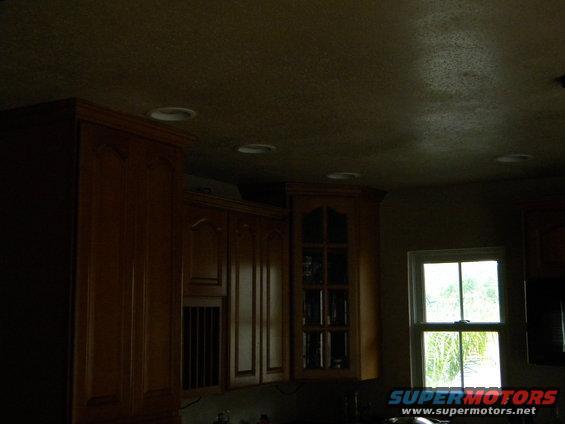 kitchen cabinets with a window showing trees outside