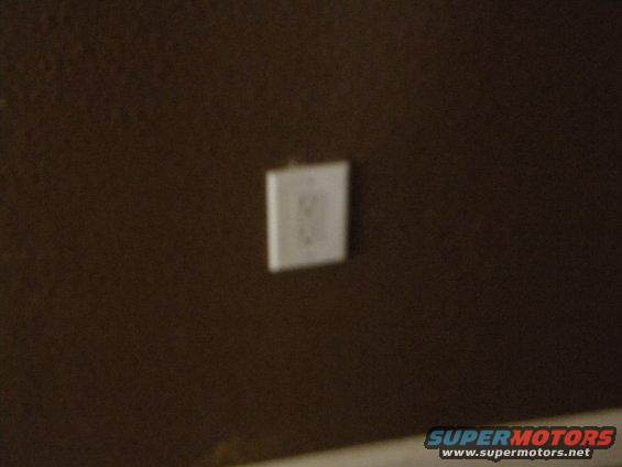 Electrical outlet on brown wall