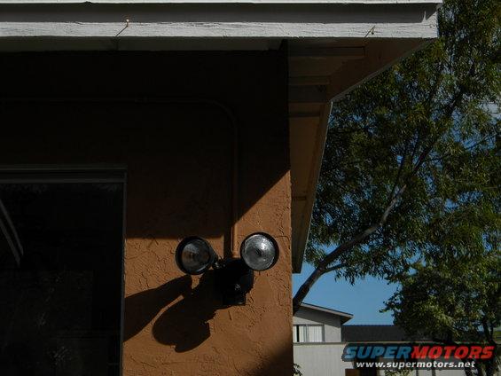 Exterior floodlight mounted on a stucco wall