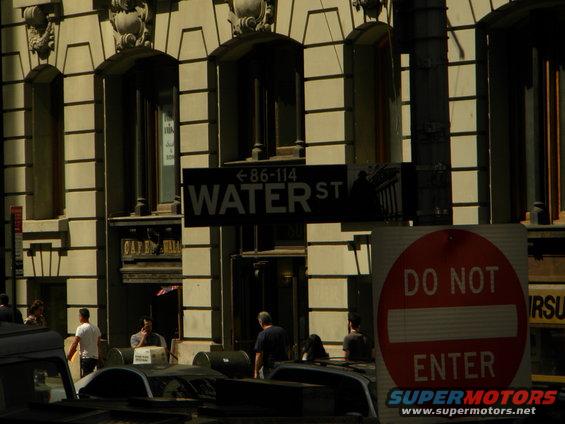 Street sign for Water St and a 'Do Not Enter' sign in front of a building